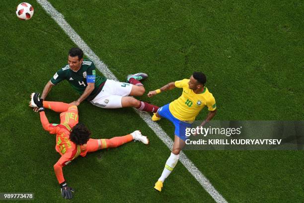 Brazil's forward Neymar vies with Mexico's goalkeeper Guillermo Ochoa and Mexico's midfielder Rafael Marquez during the Russia 2018 World Cup round...