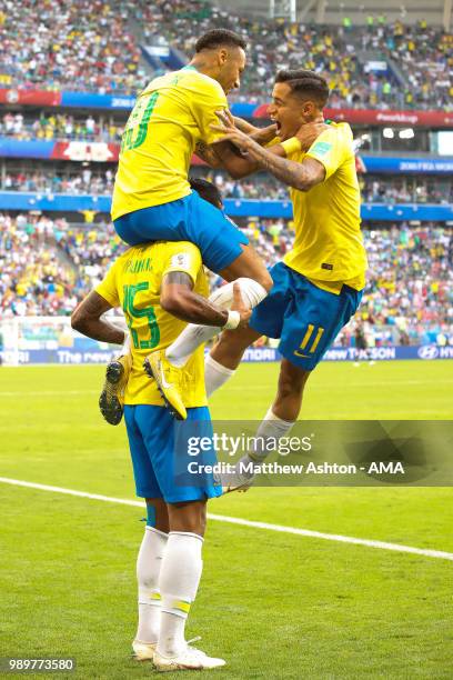 Neymar of Brazil celebrates scoring a goal to make it 1-0 with Paulinho and Philippe Coutinho during the 2018 FIFA World Cup Russia Round of 16 match...
