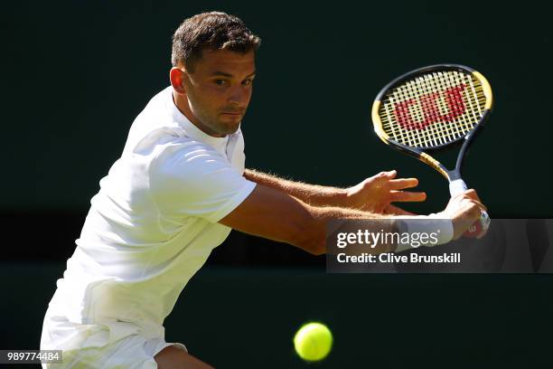 Grigor Dimitrov of Bulgaria returns against Stanislas Wawrinka of Switzerland during their Men's Singles first round match on day one of the...