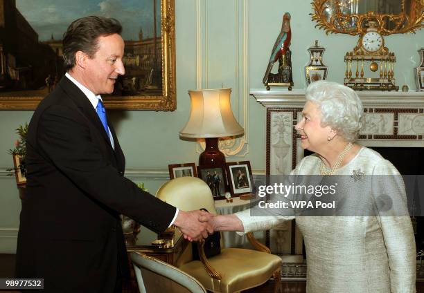 Britain's Queen Elizabeth II greets David Cameron at Buckingham Palace in an audience to invite him to be the next Prime Minister, on May 11, 2010 in...