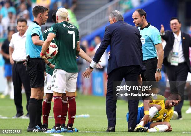 Miguel Layun of Mexico speaks with referee Gianluca Rocchi as Neymar Jr of Brazil goes down injured during the 2018 FIFA World Cup Russia Round of 16...