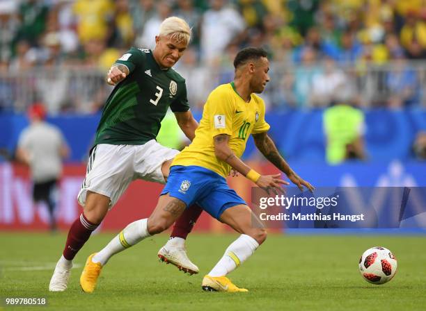 Neymar Jr of Brazil is challenged by Carlos Salcedo of Mexico during the 2018 FIFA World Cup Russia Round of 16 match between Brazil and Mexico at...