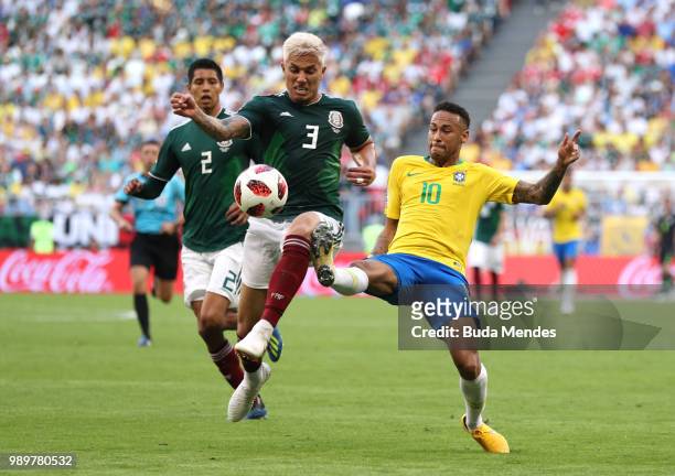 Neymar Jr of Brazil challenge for the ball with Carlos Salcedo of Mexico during the 2018 FIFA World Cup Russia Round of 16 match between Brazil and...