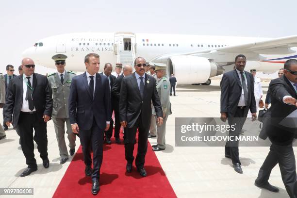 Mauritania President Mohamed Ould Abdel Aziz welcomes French President Emmanuel Macron upon his arrival in Nouakchott on July 2, 2018. - Macron,...