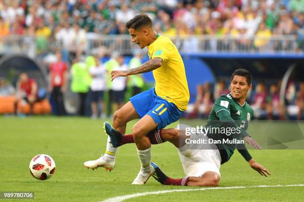 Hugo Ayala of Mexico tackles Philippe Coutinho of Brazil during the 2018 FIFA World Cup Russia Round of 16 match between Brazil and Mexico at Samara...