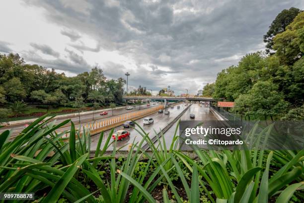 cars moving in circuito interior highway in mexico city - establishing shot stock pictures, royalty-free photos & images