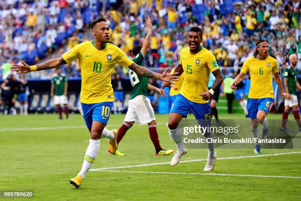 Neymar of Brazil celebrates with teammate Paulinho after scoring his sides first goal during the 2018 FIFA World Cup Russia Round of 16 match between...