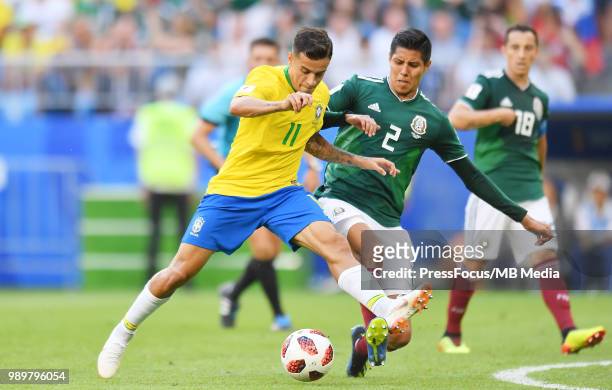 Philippe Coutinho of Brazil competes with Hugo Ayala of Mexico during the 2018 FIFA World Cup Russia Round of 16 match between Brazil and Mexico at...