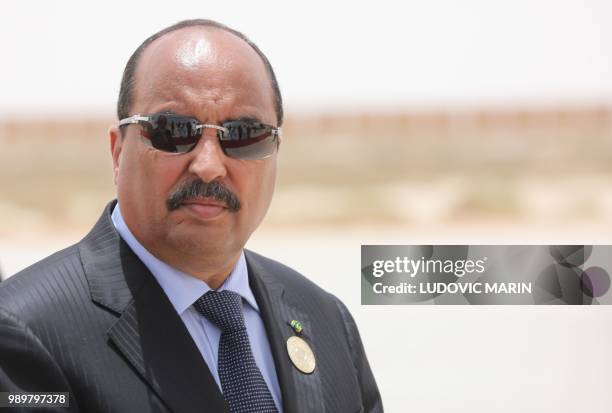 Mauritanian President Mohamed Ould Abdel Aziz waits for the arrival of the French President at Nouakchott airport on July 2, 2018. - The French...