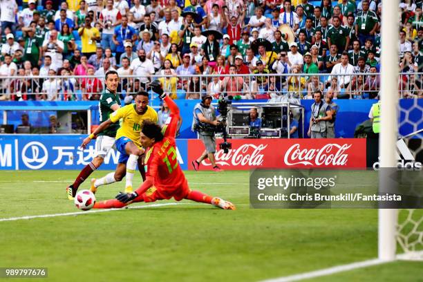 Neymar of Brazil passes the ball across the box past Guillermo Ochoa of Mexico to setup his sides second goal during the 2018 FIFA World Cup Russia...