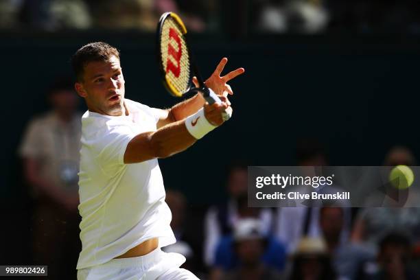 Grigor Dimitrov of Bulgaria returns against Stanislas Wawrinka of Switzerland during their Men's Singles first round match on day one of the...