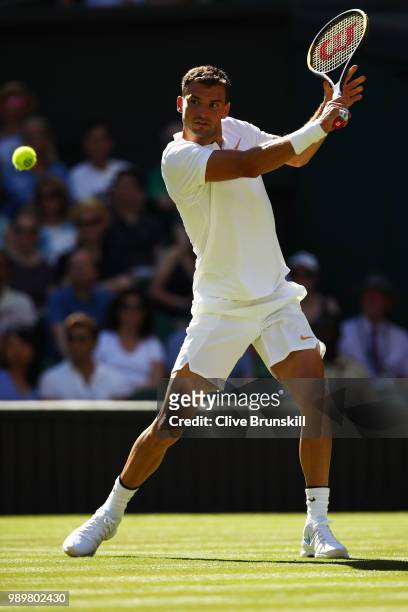 Grigor Dimitrov of Bulgaria returns against Stanislas Wawrinka of Switzerland during their Men's Singles first round match on day one of the...