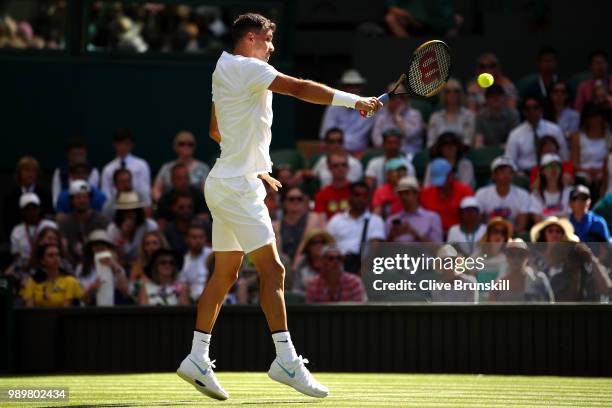 Grigor Dimitrov of Bulgaria returns against Stanislas Wawrinka of Switzerland during their Men's Singles first round match on day one of the...