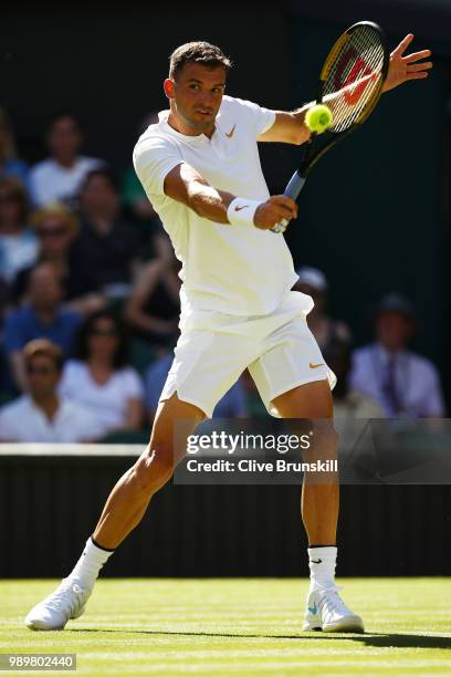 Grigor Dimitrov of Bulgaria returns against Stanislas Wawrinka of Switzerland during their Men's Singles first round match on day one of the...
