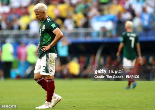 Mexico's Carlos Salcedo appears dejected after Brazil's Roberto Firmino scores his side's second goal of the game Brazil v Mexico - FIFA World Cup...