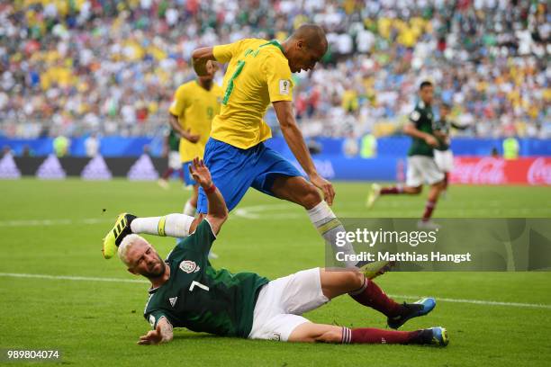 Miguel Layun of Mexico is tackled by Miranda of Brazil during the 2018 FIFA World Cup Russia Round of 16 match between Brazil and Mexico at Samara...