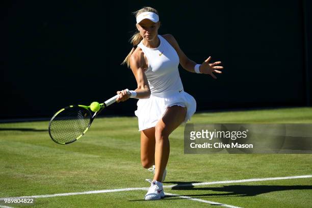 Katie Swan of Great Britain returns against Irina-Camelia Begu of Romania during their Ladies' Singles first round match on day one of the Wimbledon...