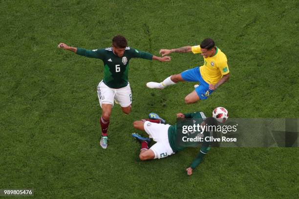 Philippe Coutinho of Brazil is tackled by Hugo Ayala and Jonathan Dos Santos of Mexico during the 2018 FIFA World Cup Russia Round of 16 match...