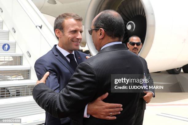 Mauritania President Mohamed Ould Abdel Aziz welcomes French President Emmanuel Macron upon his arrival at Nouakchott on July 2, 2018. - Macron,...
