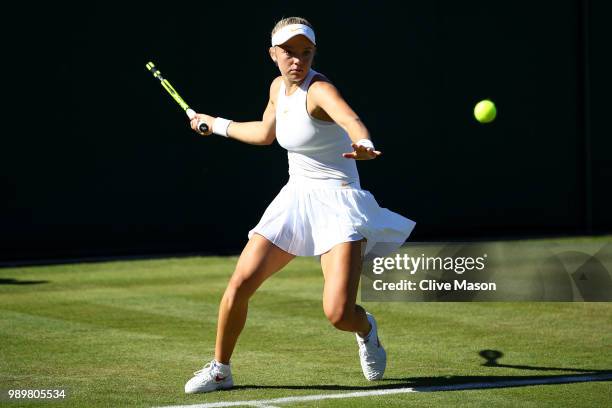 Katie Swan of Great Britain returns against Irina-Camelia Begu of Romania during their Ladies' Singles first round match on day one of the Wimbledon...