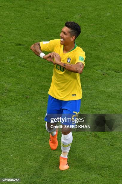 Brazil's forward Roberto Firmino celebrates his goal during the Russia 2018 World Cup round of 16 football match between Brazil and Mexico at the...