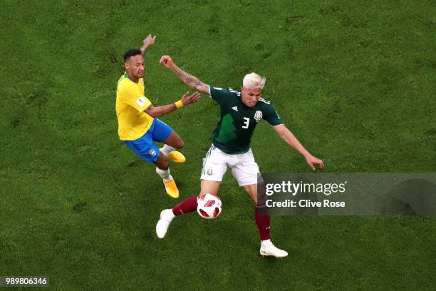 Neymar Jr of Brazil tackles Carlos Salcedo of Mexico during the 2018 FIFA World Cup Russia Round of 16 match between Brazil and Mexico at Samara...