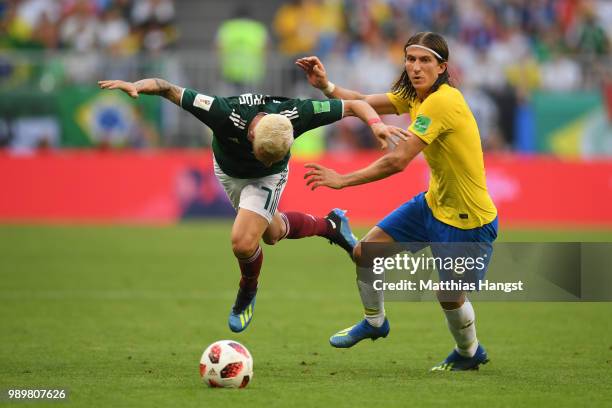 Miguel Layun of Mexico is tackled by Filipe Luis of Brazil during the 2018 FIFA World Cup Russia Round of 16 match between Brazil and Mexico at...