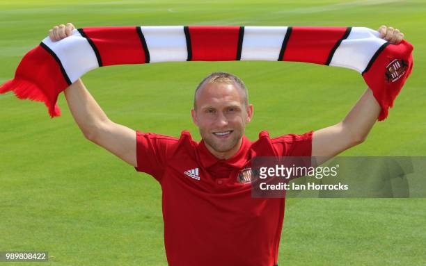 New signing Dylan McGeouch holds up a scarf at The Academy of Light on July 2, 2018 in Sunderland, England.