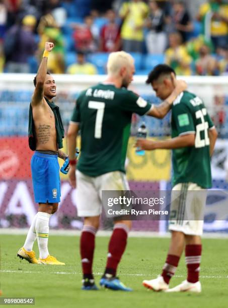 Mexico players look dejected as Neymar Jr of Brazil celebrates following his sides victory in the 2018 FIFA World Cup Russia Round of 16 match...