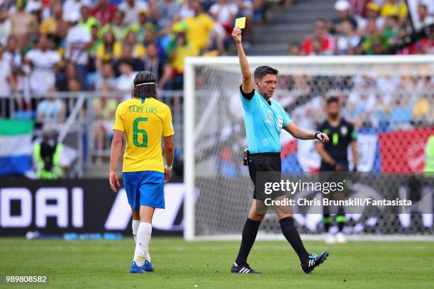 Referee Gianluca Rocchi shows Filipe Luis of Brazil a yellow card during the 2018 FIFA World Cup Russia Round of 16 match between Brazil and Mexico...