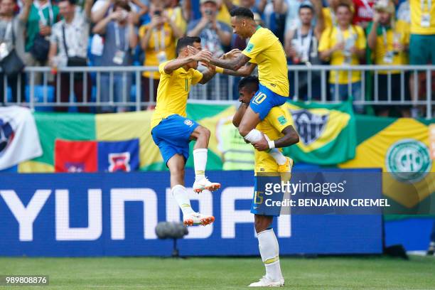 Brazil's forward Neymar celebrates with Brazil's forward Philippe Coutinho scoring the opening goal, on shoulders of Brazil's midfielder Paulinho...