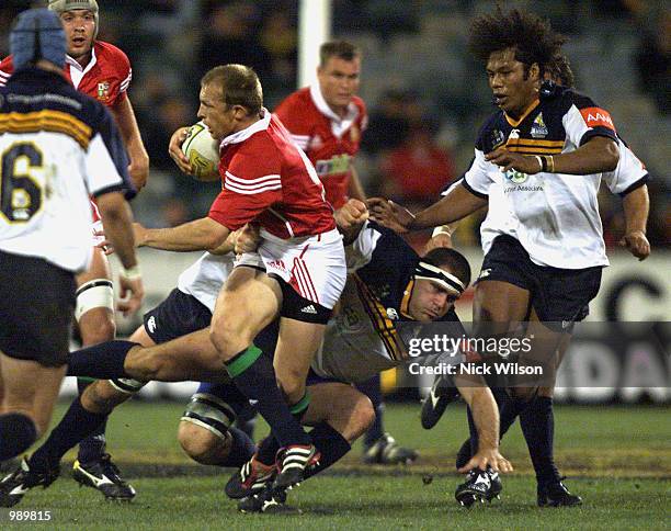 Matt Dawson of the British and Irish Lions evades the tackle of Angus Scott of the ACT Brumbies during the match between the British and Irish Lions...