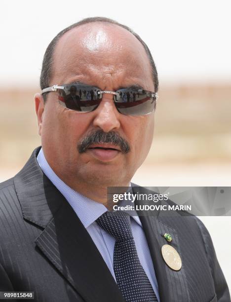 Mauritanian President Mohamed Ould Abdel Aziz waits for the arrival of the French President at Nouakchott airport on July 2, 2018. - The French...
