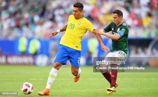 Roberto Firmino of Brazil competes with Andres Guardado of Mexico during the 2018 FIFA World Cup Russia Round of 16 match between Brazil and Mexico...