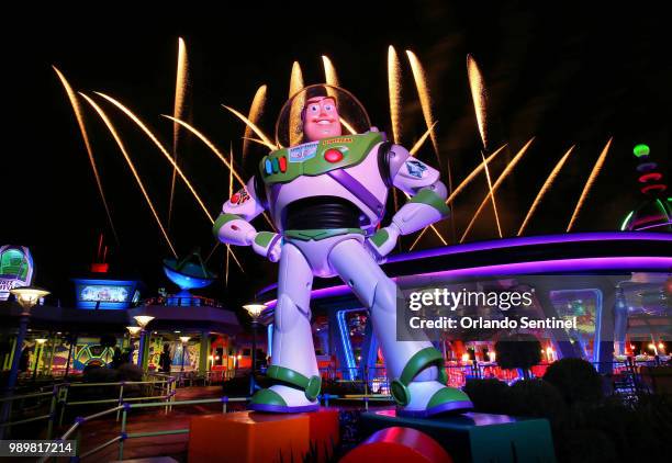 Fireworks launch behind a giant statue of the Buzz Lightyear character at the new Toy Story Land at Disney's Hollywood Studios on Thursday, June 28,...