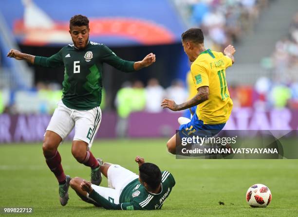 Brazil's forward Philippe Coutinho runs and vies for the ball with Mexico's defender Hugo Ayala and Mexico's midfielder Jonathan dos Santos during...