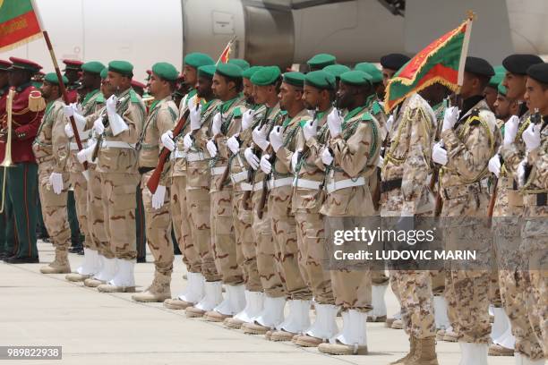 Members of the Mauritanian honour guard wait on the tarmac for the arrival of the French President to Nouakchott airport where he will later take...