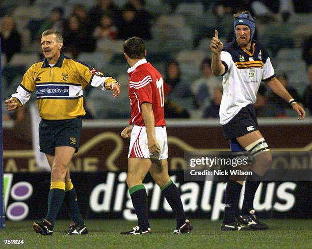 Referee Peter Marshall restrains Austin Healey of the British and Irish Lions as he clashes with a vocal Justin Harrison of the ACT Brumbies during...