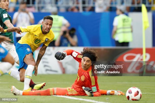 Neymar of Brazil in action against Guillermo Ochoa of Mexico during the 2018 FIFA World Cup Russia Round of 16 match between Brazil and Mexico at the...