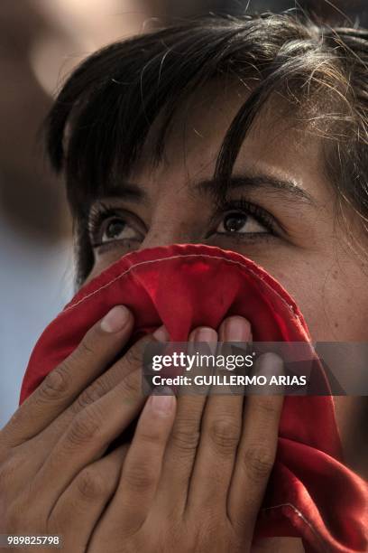 Fan of Mexico reacts as she watches the World Cup football match between Mexico and Brazil during a public event at the Angel de la Independencia...