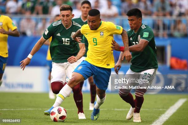 Gabriel Jesus of Brazil competes with Hector Herrera and Jesus Gallardo of Mexico during the 2018 FIFA World Cup Russia Round of 16 match between...