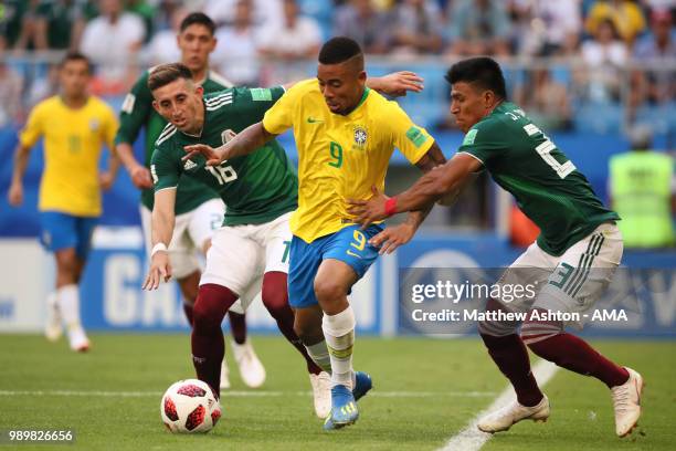 Gabriel Jesus of Brazil competes with Hector Herrera and Jesus Gallardo of Mexico during the 2018 FIFA World Cup Russia Round of 16 match between...