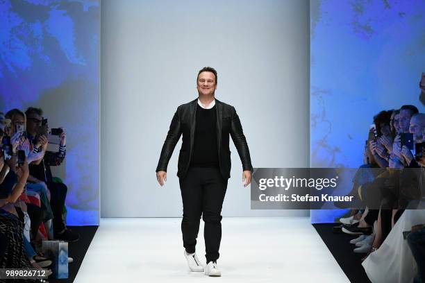 Designer Guido Maria Kretschmer acknowledges the applause of the audience after his show during the Berlin Fashion Week Spring/Summer 2019 at ewerk...