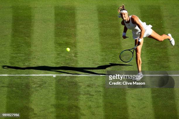 Arantxa Rus of The Netherlands serves against Serena Williams of The United States during their Ladies' Singles first round match on day one of the...
