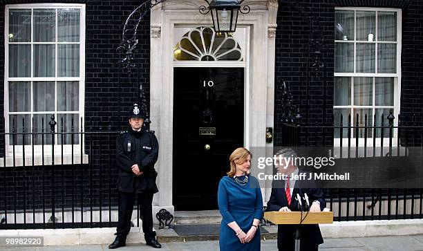 British Prime Minister Gordon Brown speaks to the media beside his wife Sarah as Brown resigns, in Downing Street on May 11, 2010 in London, England....