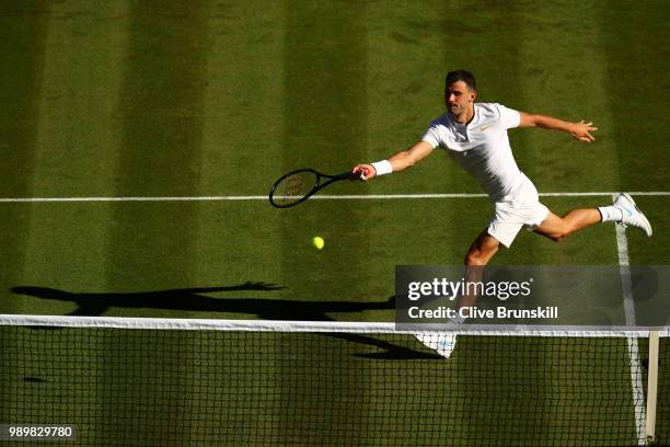 Grigor Dimitrov of Bulgaria returns against Stanislas Wawrinka of Switzerland during their Men's Singles first round match on day one of the...