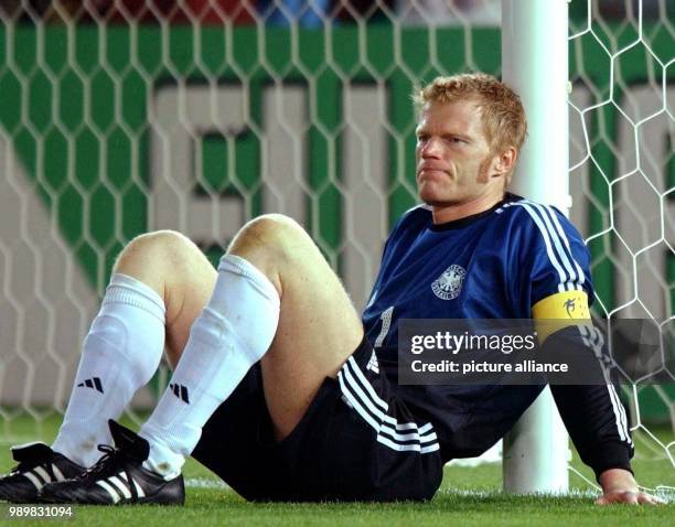 German goalkeeper and team captain Oliver Kahn leans depressed against the goal post after the end of the game. The German national team loses the...