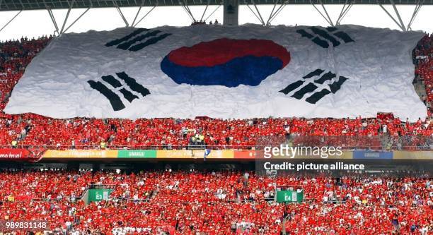 Thousands of South Korean soccer fans unfurl their country's national flag as they eagerly await the start of the FIFA World Cup 2002 quarter-final...