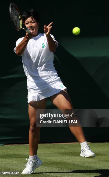 Thailand's Luksika Kumkhum returns against US player Bernarda Pera during their women's singles first round match on the first day of the 2018...