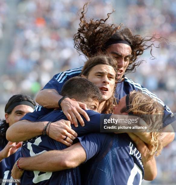 Argentinean players Juan Pablo Sorin, Mauricio Pochettino and Walter Samuel embrace and celebrate their teammate and Gabriel Batistuta who has just...
